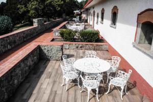 a patio with a table and chairs on a deck at Centro Vacacional La Trinidad in Santa María Atlihuetzián +31 photos