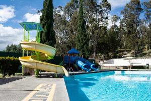 a pool with a slide and a water park at Centro Vacacional La Trinidad in Santa María Atlihuetzián
