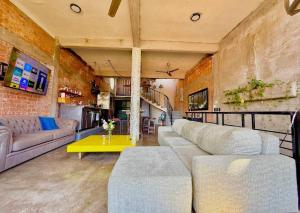 a living room with a couch and a table at Casa Maruja CoLiving Walk to Beach in Puerto Vallarta