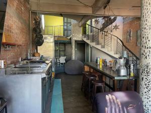 a kitchen with a counter and some chairs in a room at Casa Maruja CoLiving Walk to Beach in Puerto Vallarta +18 photos