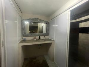 a bathroom with a sink and a mirror at Casa Maruja CoLiving Walk to Beach in Puerto Vallarta