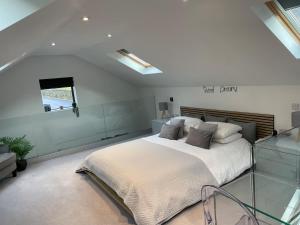 a bedroom with a large bed and a window at The Old Quarry Hideaway in Cowling