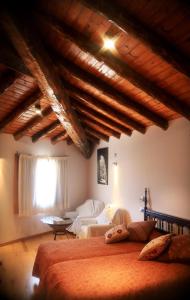 a bedroom with a bed and a living room at Hotel Can Borrell in Meranges