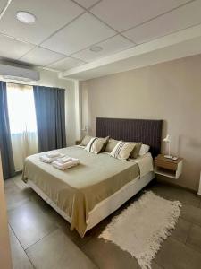 a bedroom with a large bed with towels on it at Concepcion Apart in Concepción