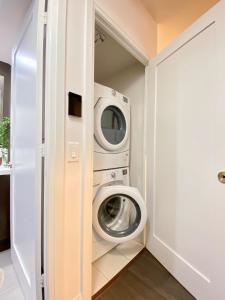 a laundry room with a washer and dryer at Luxurious Condo Apartment with Direct Subway Access in Toronto +4 photos