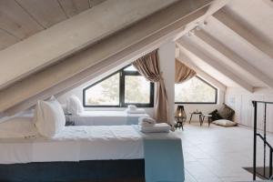 a bedroom with two beds and a large window at Ariti Luxury Apartment in Nikiana +43 photos