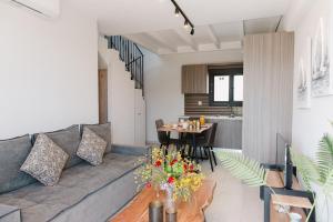 a living room with a couch and a table at Ariti Luxury Apartment in Nikiana