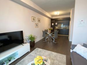 a living room with a large flat screen tv at Luxurious Condo Apartment with Direct Subway Access in Toronto
