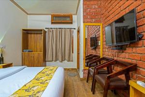 a bedroom with a bed and a brick wall at By the Lake Boho Bhimtal in Bhīm Tāl +28 photos