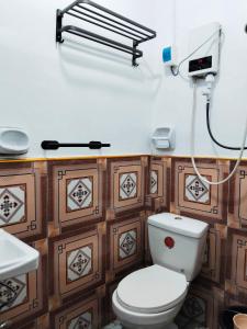 a bathroom with a toilet and a sink at Batad Pension Ph in Banaue