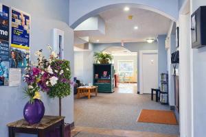 a hallway with a vase of flowers on a table at Mountain View Inn in Canmore