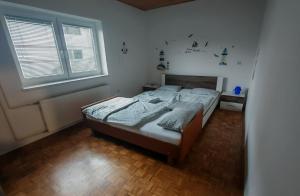a bedroom with a bed and a large window at Lusana in Moravske-Toplice +3 photos
