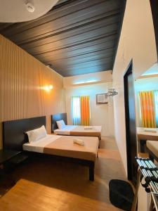 a bedroom with two beds in a room at First Pacific Inn Davao in Davao City
