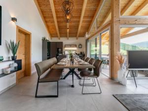 a dining room with a table and chairs at Grebenzen Lodge 55 in Sankt Lambrecht