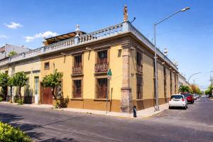 a yellow building on the side of a street at Casa Brusodia in Guadalajara