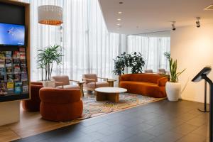 a lobby with couches and chairs and a table at Song Hotel Sydney in Sydney