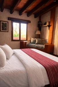 a bedroom with a large bed and a window at La Casa del Guamúchil in Tequesquitengo +97 photos