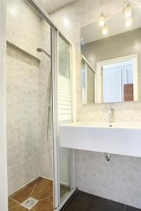 a bathroom with a shower and a sink and a mirror at Hotel Montpensier in Paris