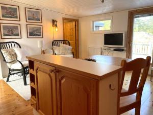 a living room with a table and a tv at 4 person holiday home in VALDERMARSVIK in Valdemarsvik