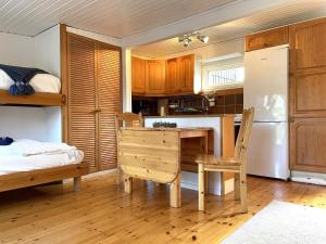 a kitchen with a wooden table and a dining room at 4 person holiday home in VALDERMARSVIK in Valdemarsvik
