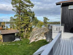 a deck with a large rock next to a building at 4 person holiday home in VALDERMARSVIK in Valdemarsvik