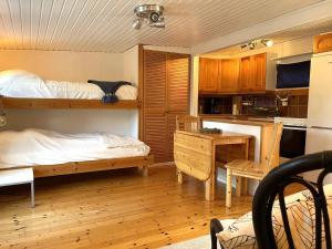 a room with two bunk beds and a kitchen at 4 person holiday home in VALDERMARSVIK in Valdemarsvik