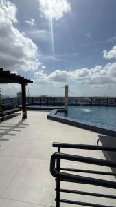 a view of a swimming pool on top of a building at Flat particular no Hotel Intercity Manaus in Manaus