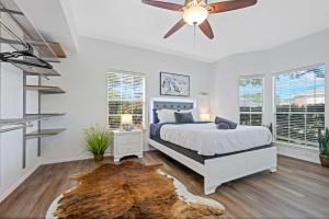 a bedroom with a bed and a ceiling fan at Meadow Park in Allen +22 photos