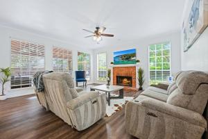 a living room with two couches and a fireplace at Meadow Park in Allen