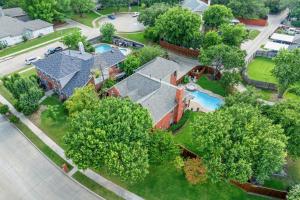 an aerial view of a house with a swimming pool at Meadow Park in Allen