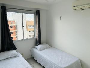 a bedroom with two beds and a window at Play Ilhotas - Centro Teresina in Teresina +12 photos