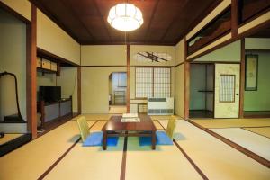 a living room with a wooden table and chairs at Fukuzumiro in Hakone