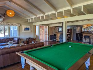 a living room with a pool table in it at Mt Potts Lodge in Ashburton Lakes