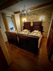 a bedroom with a large wooden bed in a room at Baboško in Rimavská Sobota