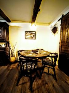 a room with a wooden table and a room with a table at Baboško in Rimavská Sobota +12 photos