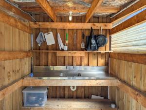 a kitchen with a sink in a wooden cabin at Mt Potts Lodge in Ashburton Lakes +29 photos
