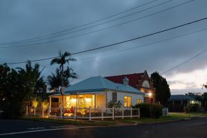 a house with its lights on in a street at Greta Cottage, Berry in Berry