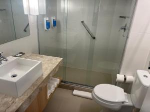 a bathroom with a shower and a sink and a toilet at Stay Santos 2301 in Santos +21 photos
