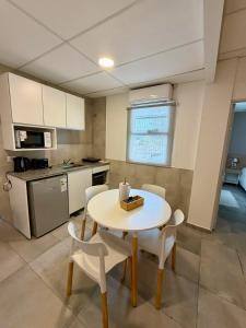 a kitchen with a table and chairs in a kitchen at Concepcion Apart in Concepción +89 photos