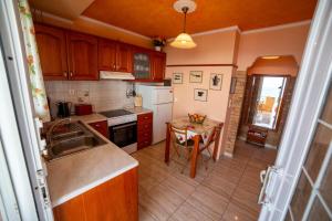 a kitchen with a sink and a table in it at Oceanfront Studio at Paramonas Beach in Paramonas