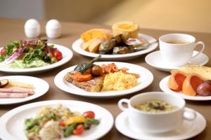 a table with plates of food and cups of coffee at Phoenix Resort Pyeongchang in Pyeongchang