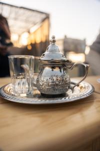 a tea pot on a plate on a table at Eco Bay Surf Camp in Aourir +106 photos