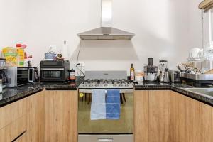 a kitchen with a stove top oven in a kitchen at SHINYADO Casa de Huéspedes Cabo San Lucas in Cabo San Lucas