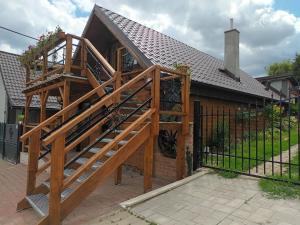 a wooden staircase leading up to a house at Hraško in Rimavská Sobota