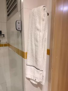 a white towel hanging on a wall in a bathroom at Apartamento Jaragua do sul in Jaraguá do Sul +26 photos