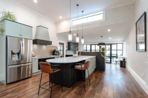 a kitchen with a island in the middle of a table at The Deco Retreat in Hawera