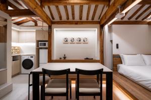 a kitchen and living room with a table and chairs at Luxury Hanok The four beauties seochon in Seoul