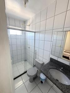 a white bathroom with a toilet and a sink at Modenesi Hotel in Linhares +21 photos
