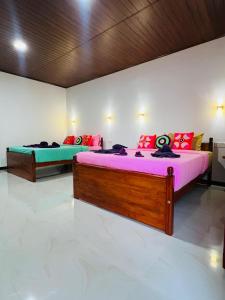 two beds in a room with purple and green at Mount View Plaza - Ella Cottage with Mountain &Valley View in Ella