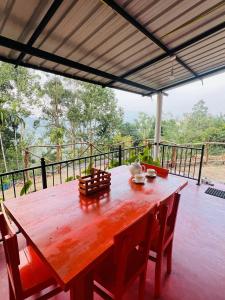 a wooden table and chairs on a porch with a view at Mount View Plaza - Ella Cottage with Mountain &Valley View in Ella